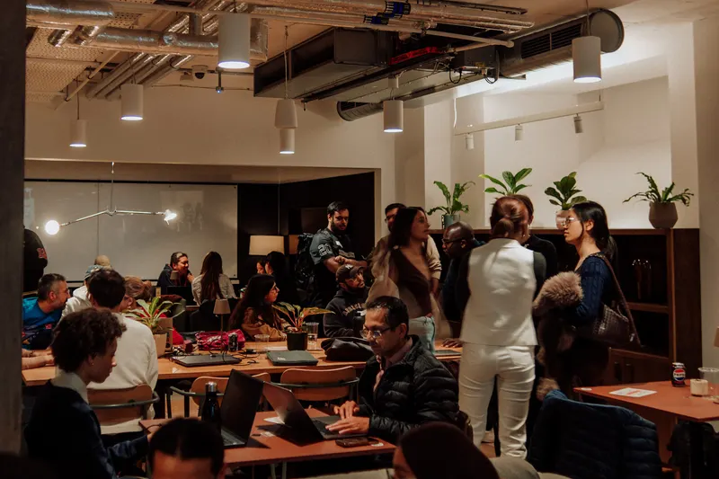 The room fills with founders sitting at tables and standing in groups at Growth Night.