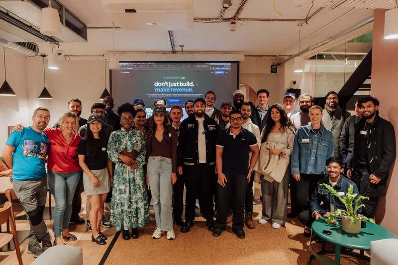 Another group photo of Growth Night founders posing together in front of the projector screen.